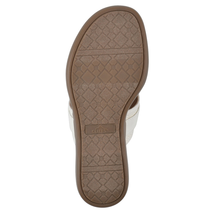 Sole view of a light beige thong sandal with a centered metal ring ornament and tan sole