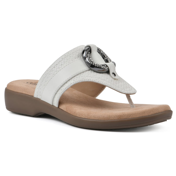 Angle view of a white thong sandal with a centered metal ring ornament and tan sole