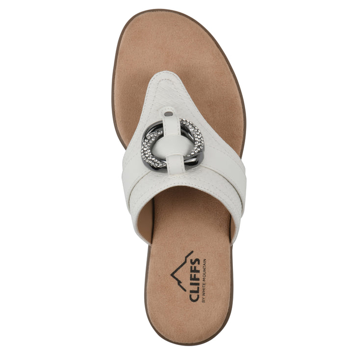 Top view of a light beige thong sandal with a centered metal ring ornament and tan sole