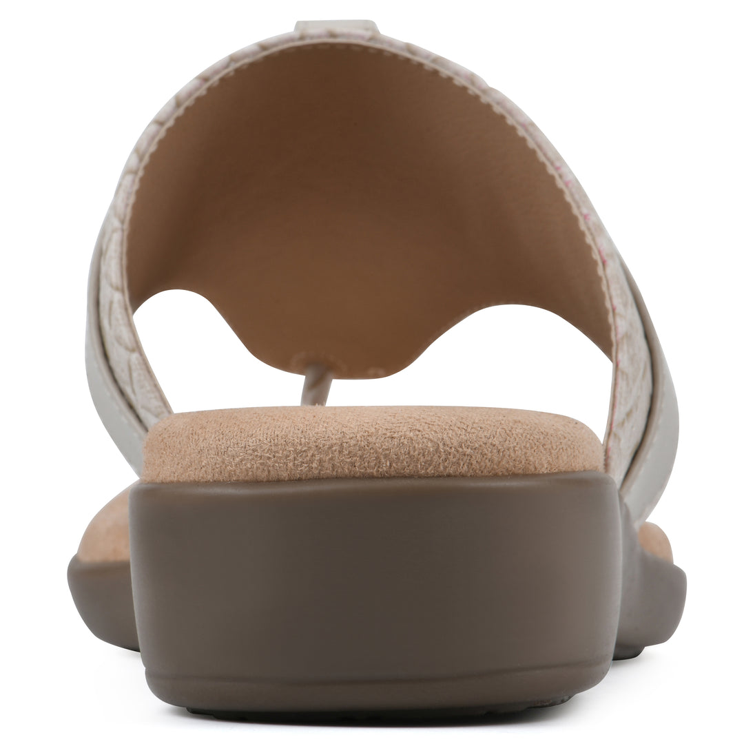 Rear view of a light beige thong sandal with a centered metal ring ornament and tan sole