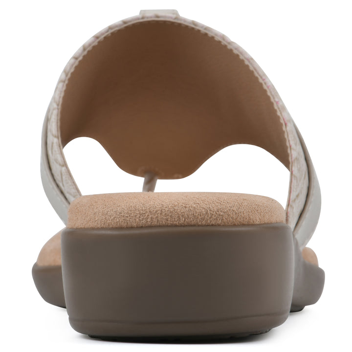 Rear view of a light beige thong sandal with a centered metal ring ornament and tan sole