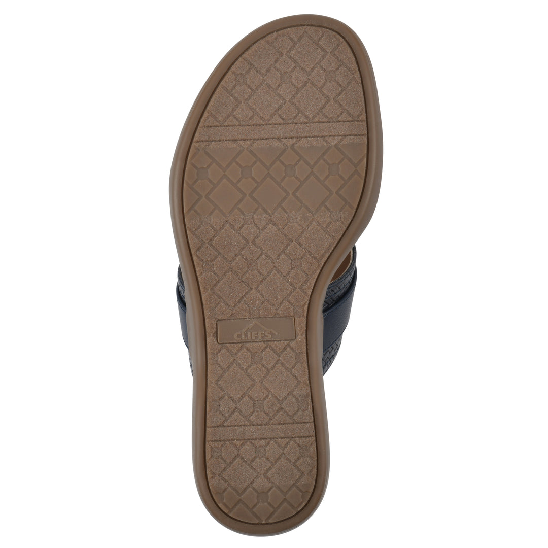 Sole view of a navy thong sandal with a centered metal ring ornament and tan sole