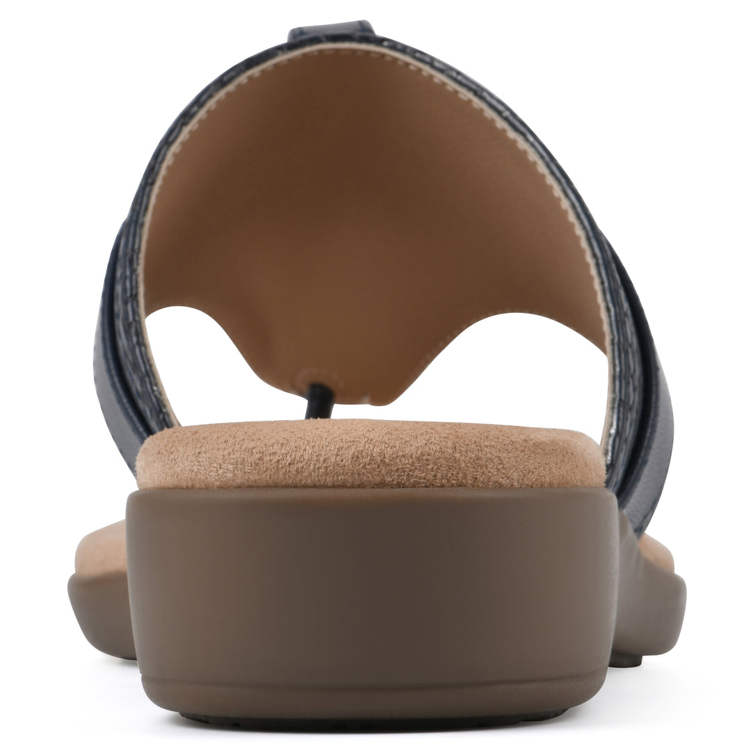 Rear view with a centered metal ring ornament and tan sole