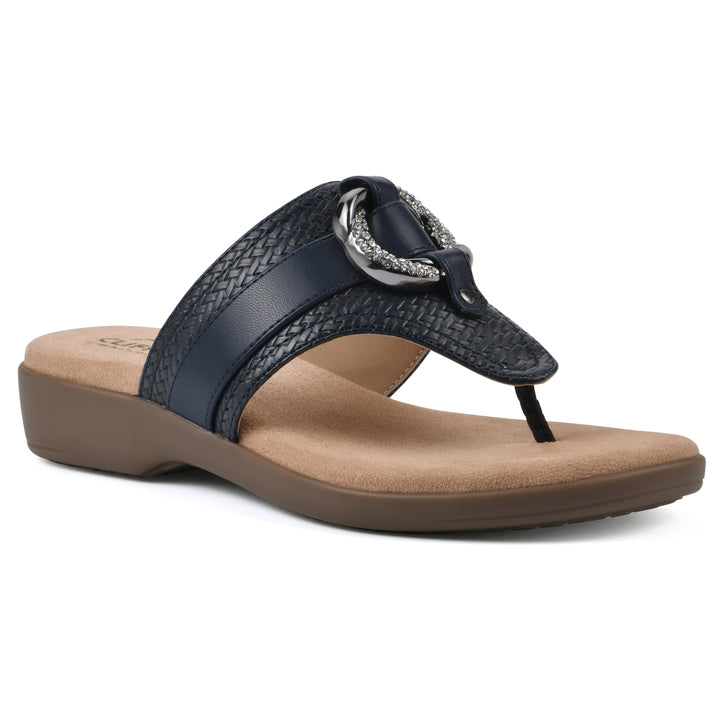 Angle view of a navy thong sandal with a centered metal ring ornament and tan sole