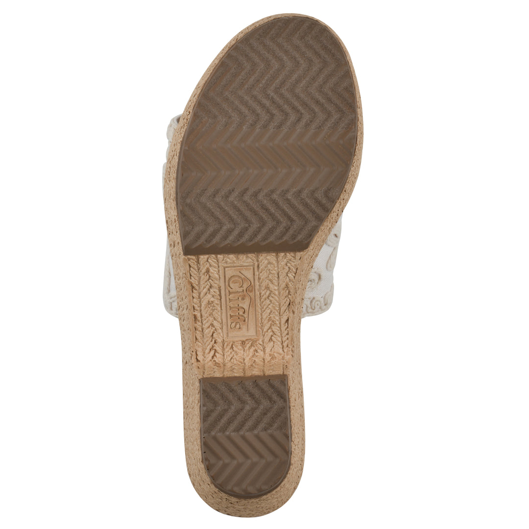 Sole view of a white wedge sandal with cream embroidered floral pattern and a braided rope-style sole