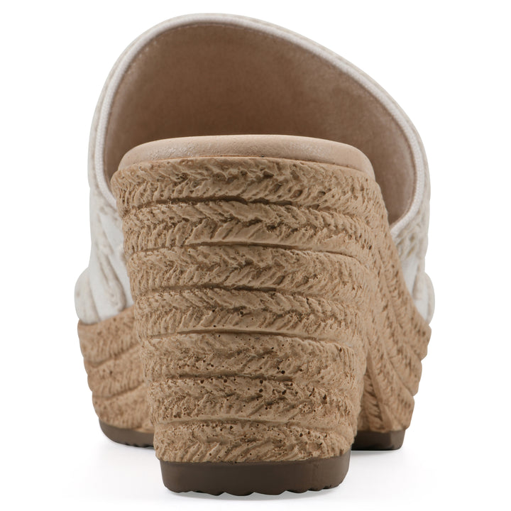 Rear view of a white wedge sandal with cream embroidered floral pattern and a braided rope-style sole