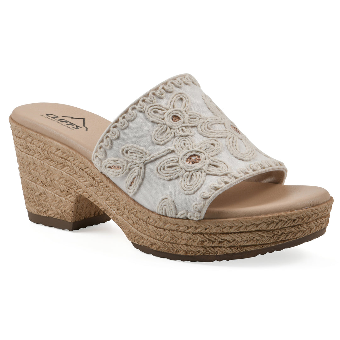 Angle view of a white wedge sandal with cream embroidered floral pattern and a braided rope-style sole