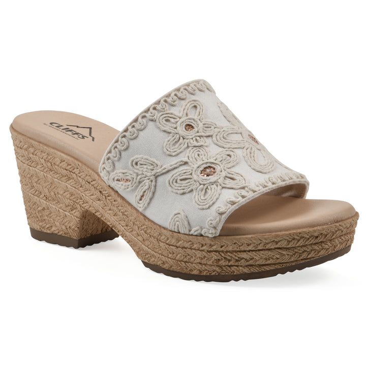 Angle view of a white wedge sandal with cream embroidered floral pattern and a braided rope-style sole
