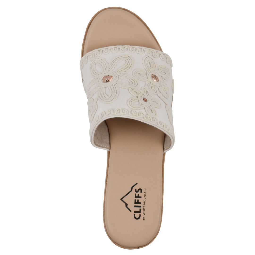Top view of a white wedge sandal with cream embroidered floral pattern and a braided rope-style sole