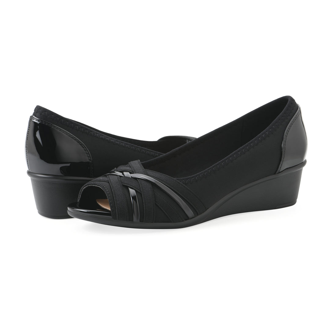 Angel view of a pair of slip on wedge with a peep toe in navy blue