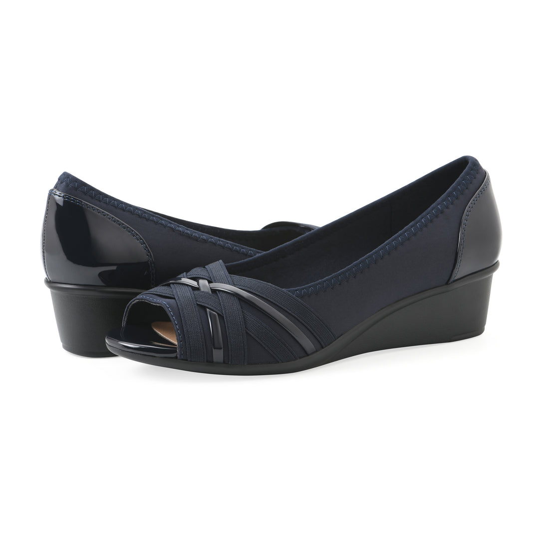 Angel view of a pair of slip on wedge with a peep toe in navy blue