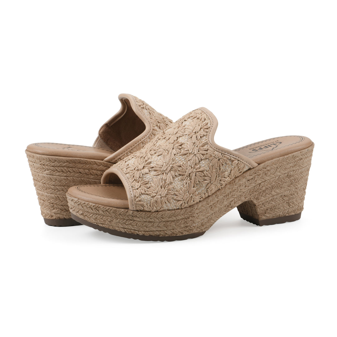 Angle view of a pair of natural beige embroidered fabric wedge sandals with a braided rope-style sole