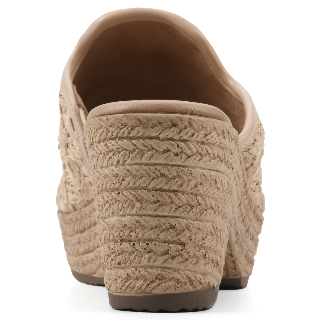 Rear view of a natural beige embroidered fabric wedge sandal with a braided rope-style sole