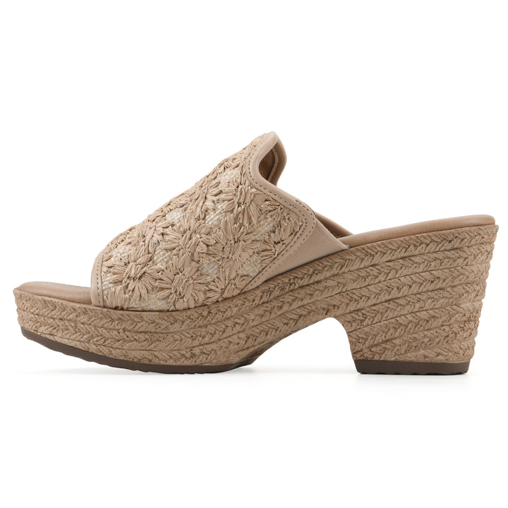 Side view of a natural beige embroidered fabric wedge sandal with a braided rope-style sole