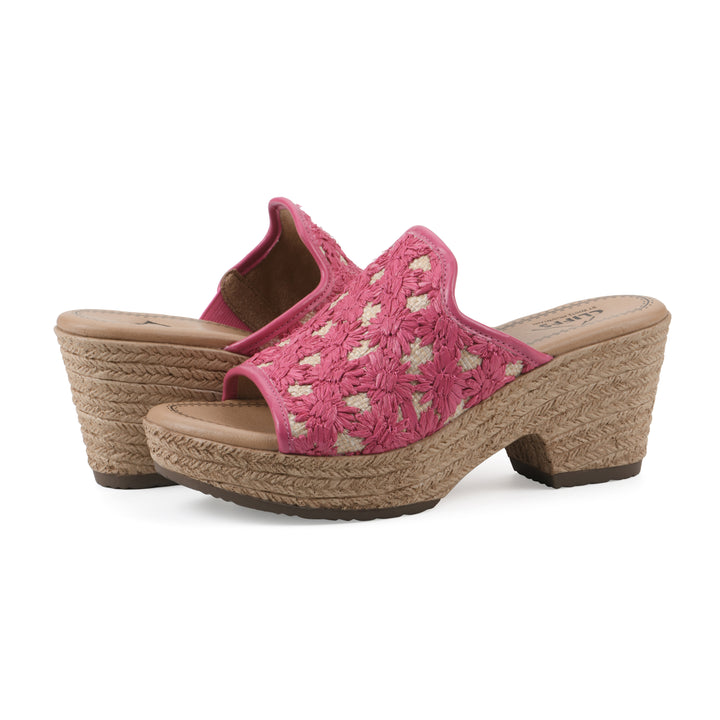 Angle view of a pair of magenta embroidered fabric wedge sandals with a braided rope-style sole