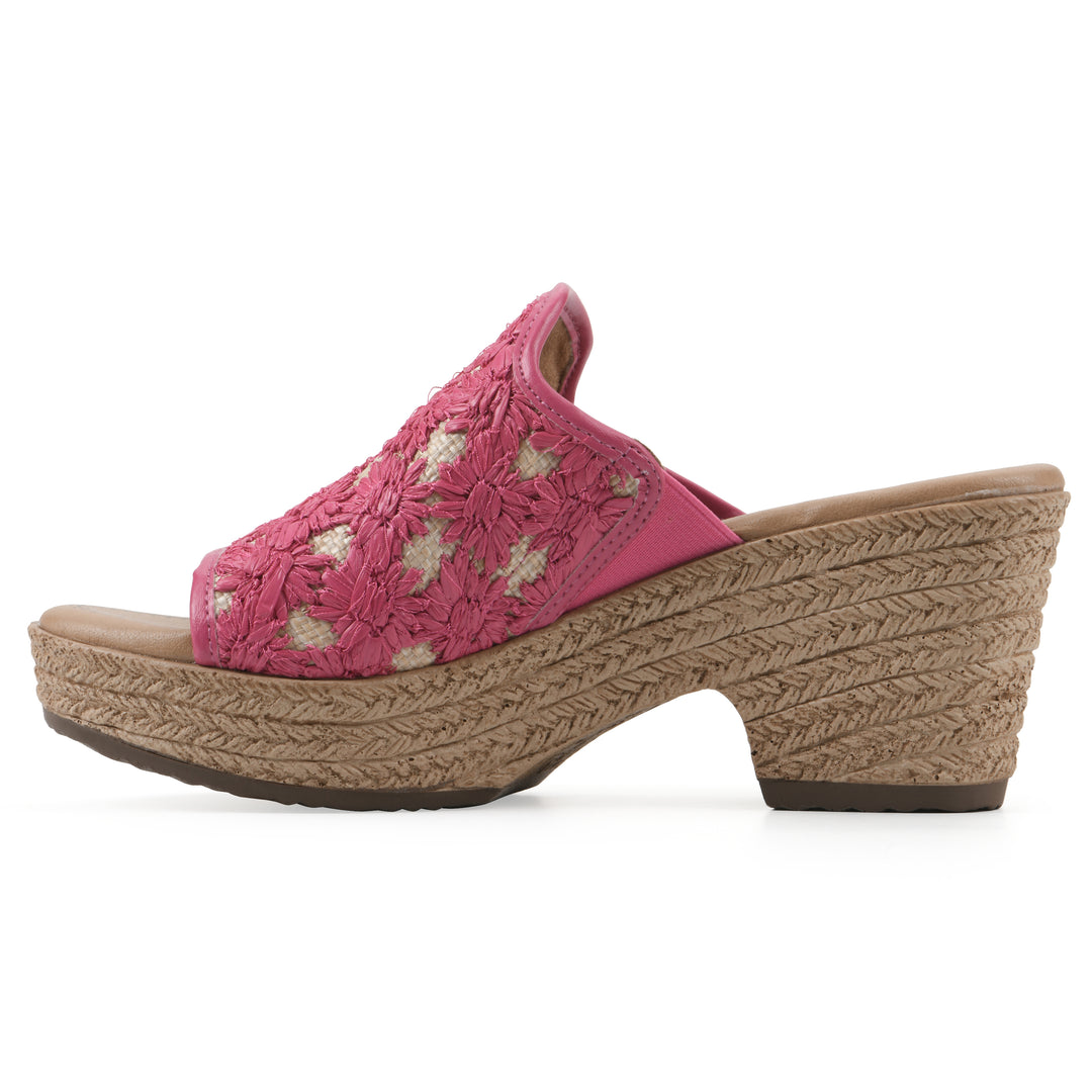 Side view of a magenta embroidered fabric wedge sandal with a braided rope-style sole