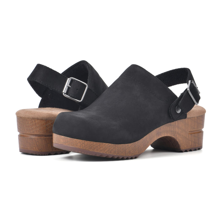 Angle view of a pair of backless black leather clogs with adjustable back strap and wood style heel