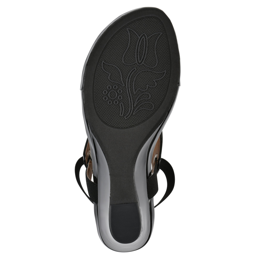 Sole view of a black patent thong wedge sandal with a wrapped heel, elastic ankle strap, and black sole