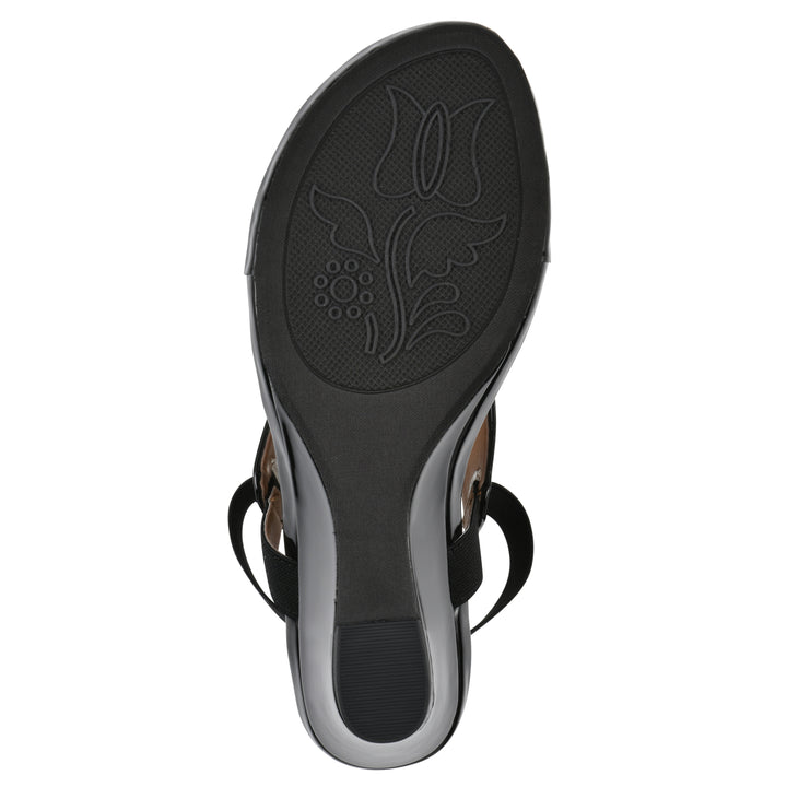 Sole view of a black patent thong wedge sandal with a wrapped heel, elastic ankle strap, and black sole