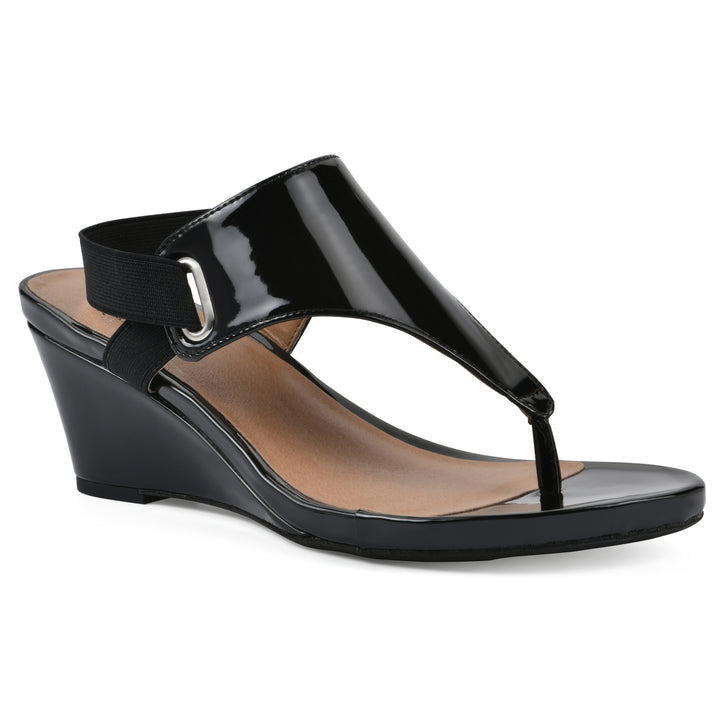 Angle view of a black patent thong wedge sandal with a wrapped heel, elastic ankle strap, and black sole