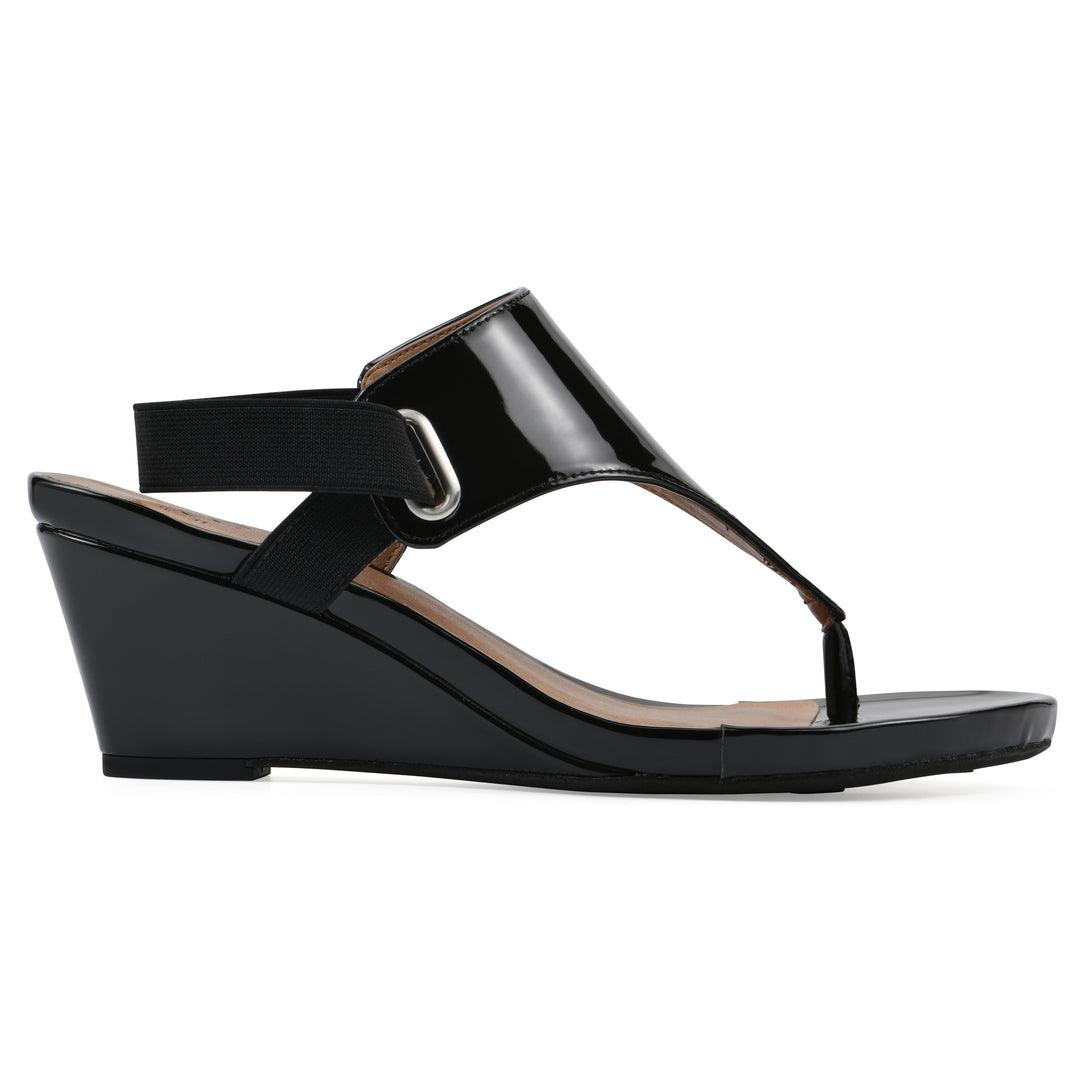 Side view of a black patent thong wedge sandal with a wrapped heel, elastic ankle strap, and black sole