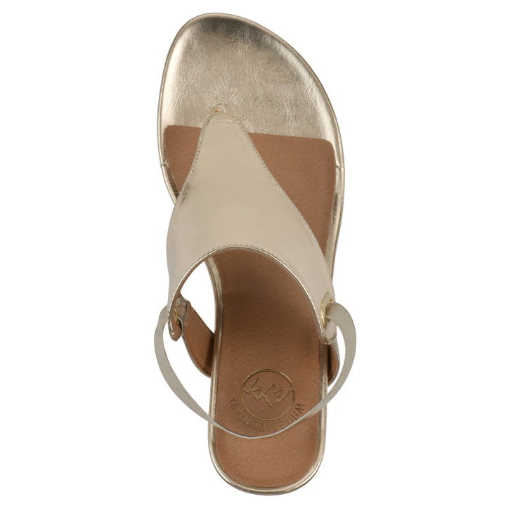 Top view of a gold metallic thong wedge sandal with a wrapped heel, elastic ankle strap, and gold sole