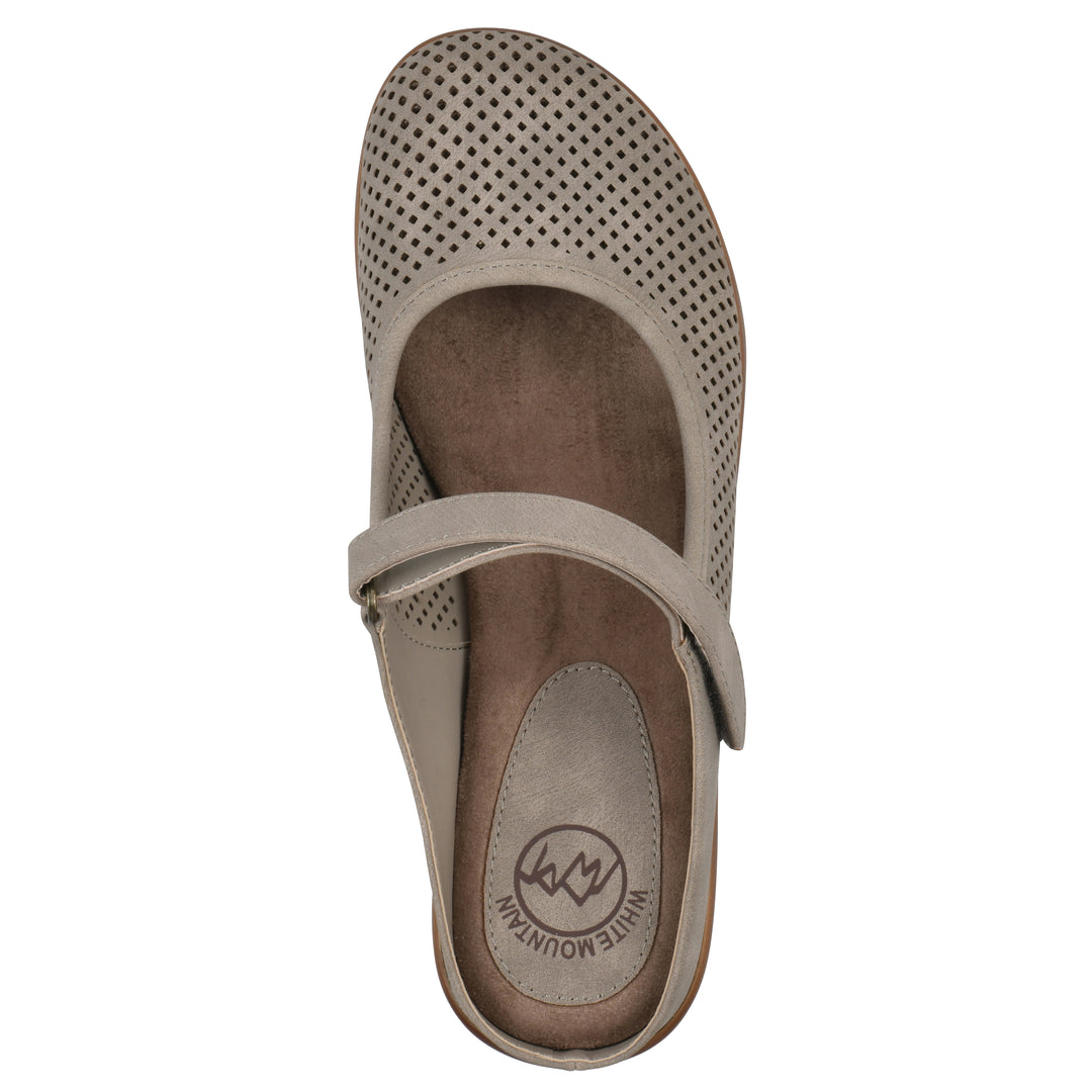 Top view of a light taupe-colored clog with a closed toe and adjustable strap, featuring a perforated diamond design and a low heel.