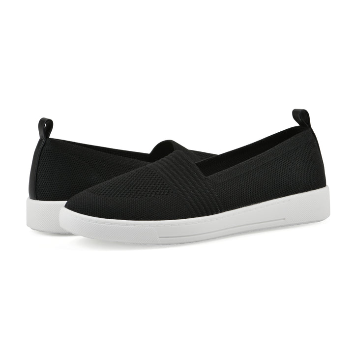 Angle view of a pair of black slip-on sneaker with white sole, and perforated mesh fabric