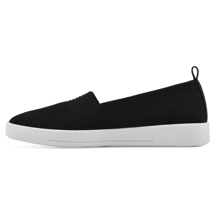 Side view of a black slip-on sneaker with white sole, and perforated mesh fabric