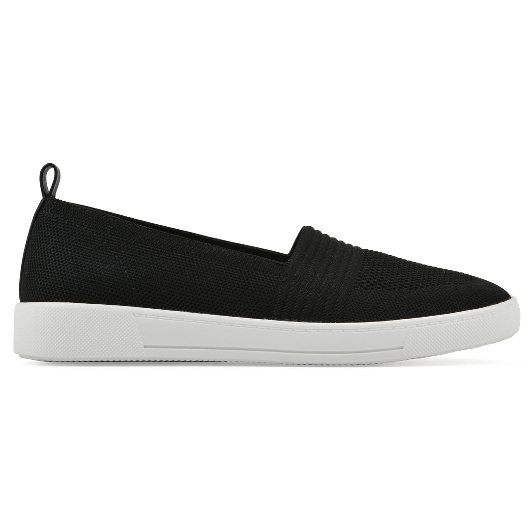 Side view of a black slip-on sneaker with white sole, and perforated mesh fabric