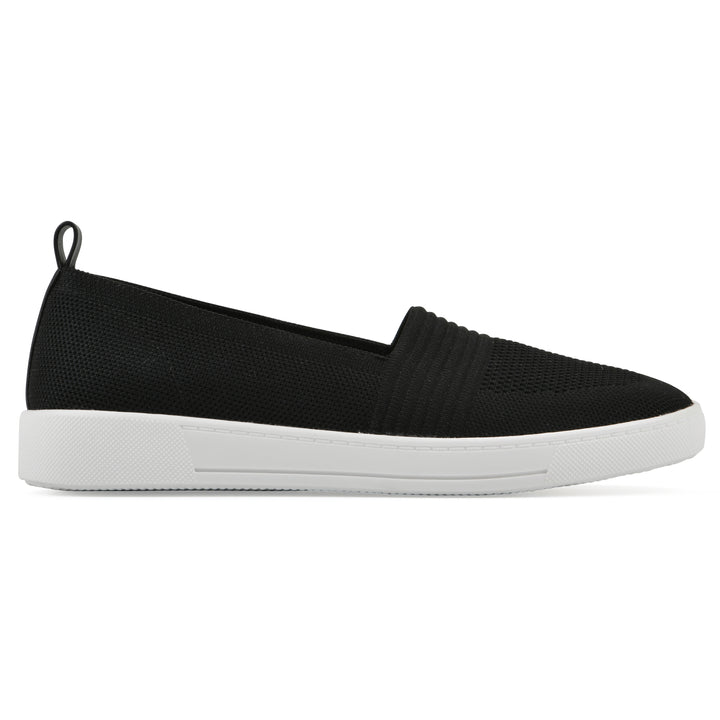 Side view of a black slip-on sneaker with white sole, and perforated mesh fabric