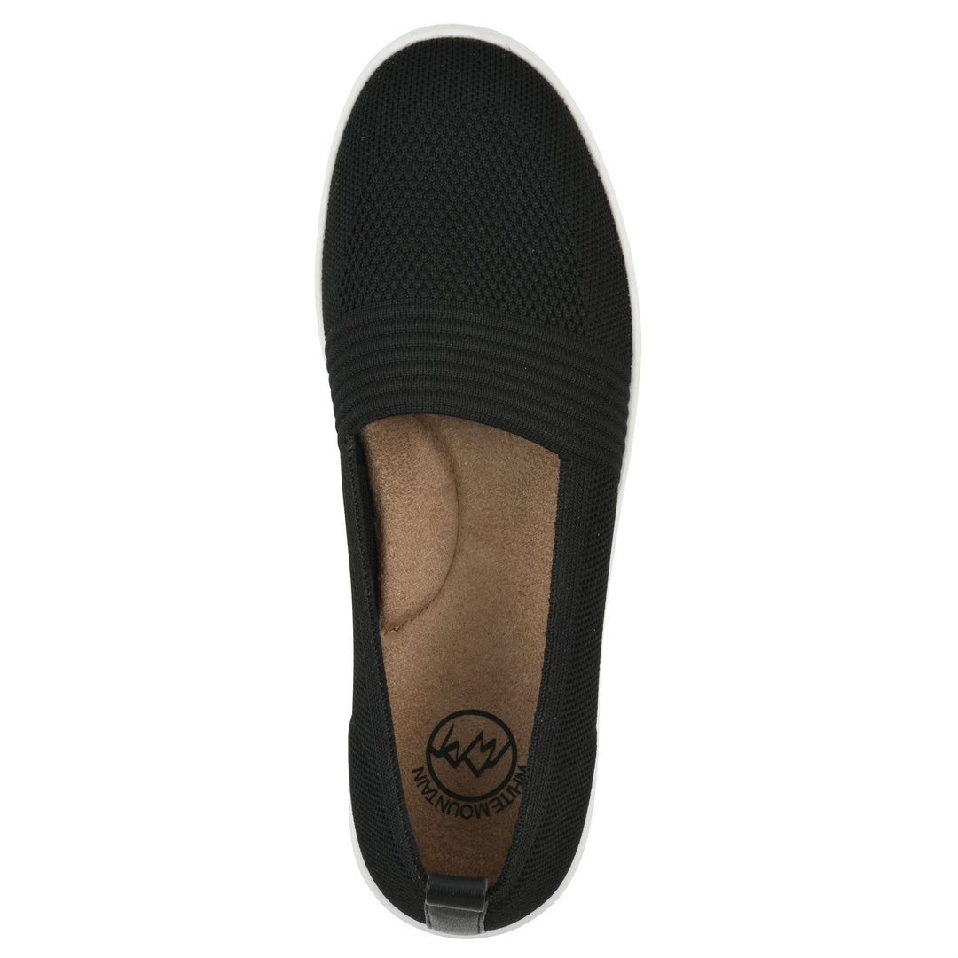 Top view of a black slip-on sneaker with white sole, and perforated mesh fabric