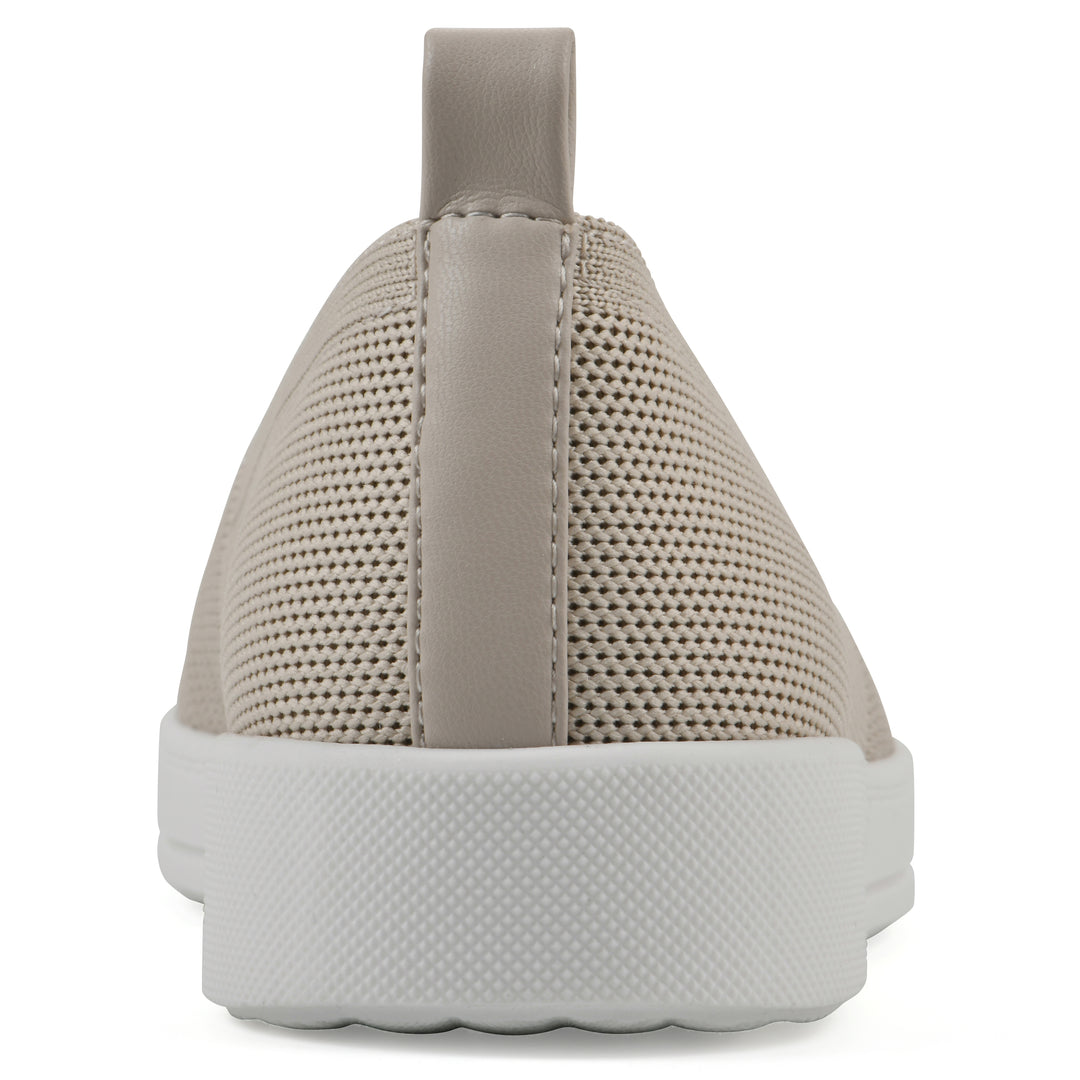 Heel view of a taupe slip-on sneaker with white sole, and perforated mesh fabric