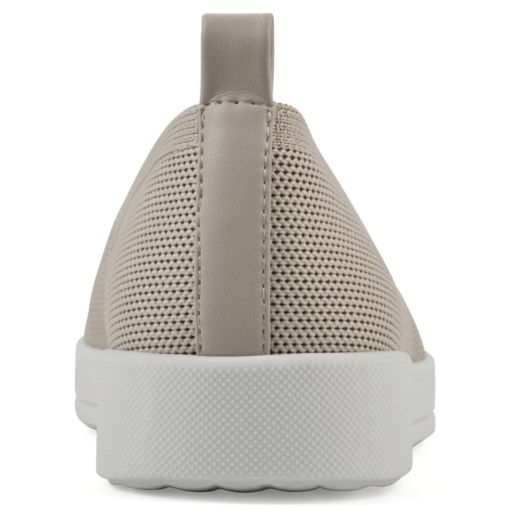 Heel view of a taupe slip-on sneaker with white sole, and perforated mesh fabric