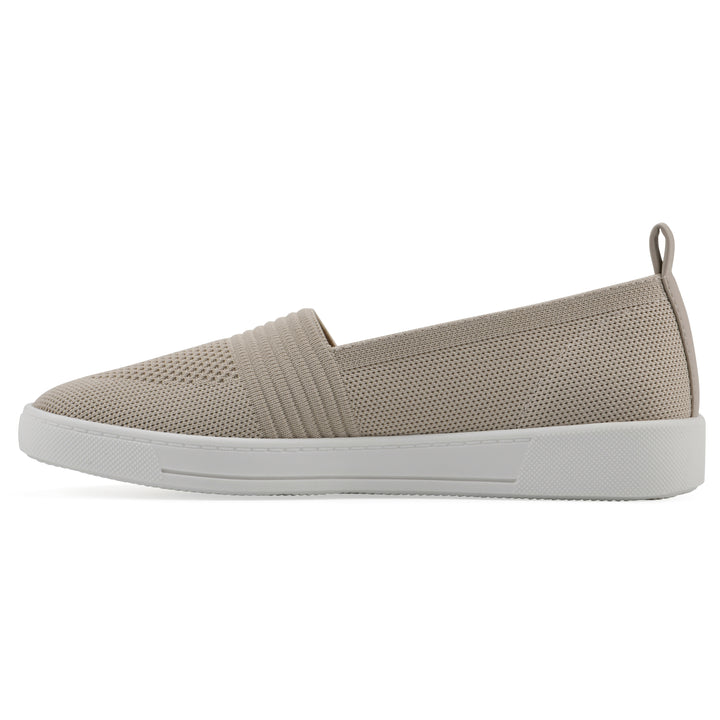 Side view of a taupe slip-on sneaker with white sole, and perforated mesh fabric