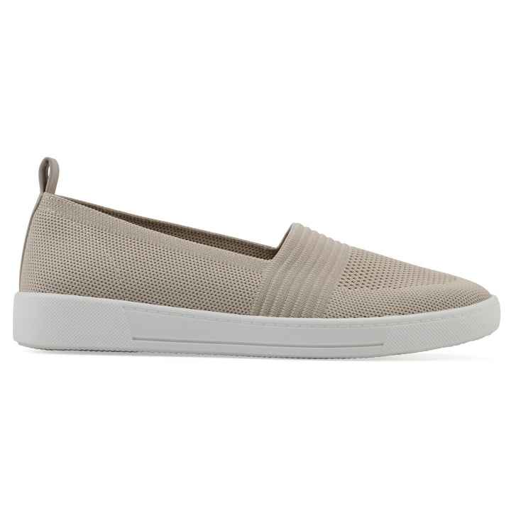 Side view of a taupe slip-on sneaker with white sole, and perforated mesh fabric