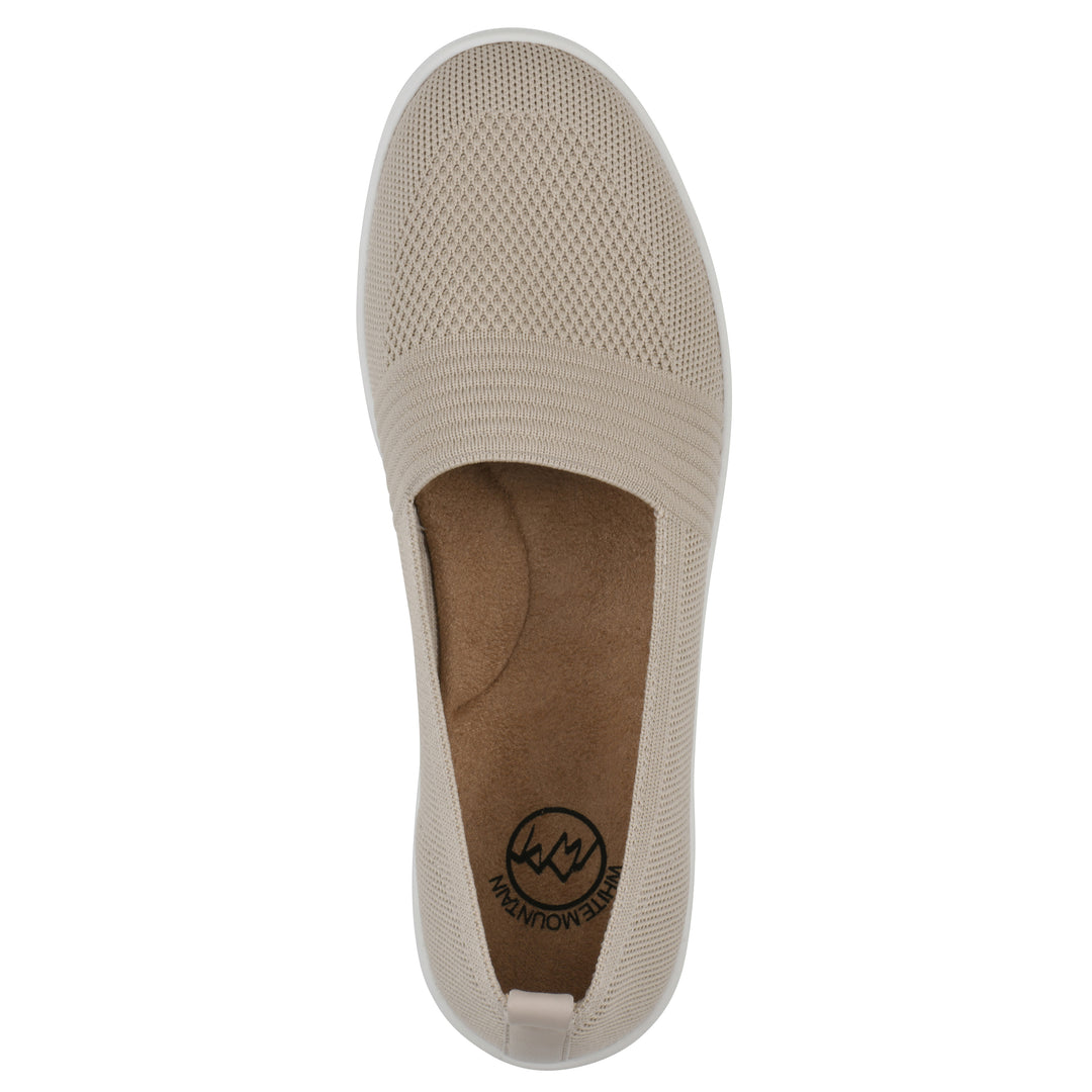Top view of a taupe slip-on sneaker with white sole, and perforated mesh fabric