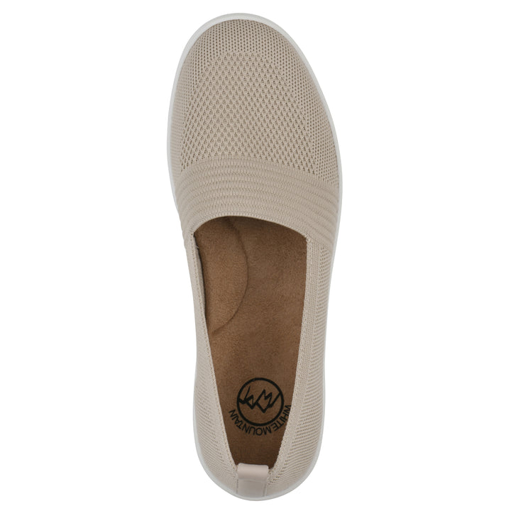 Top view of a taupe slip-on sneaker with white sole, and perforated mesh fabric
