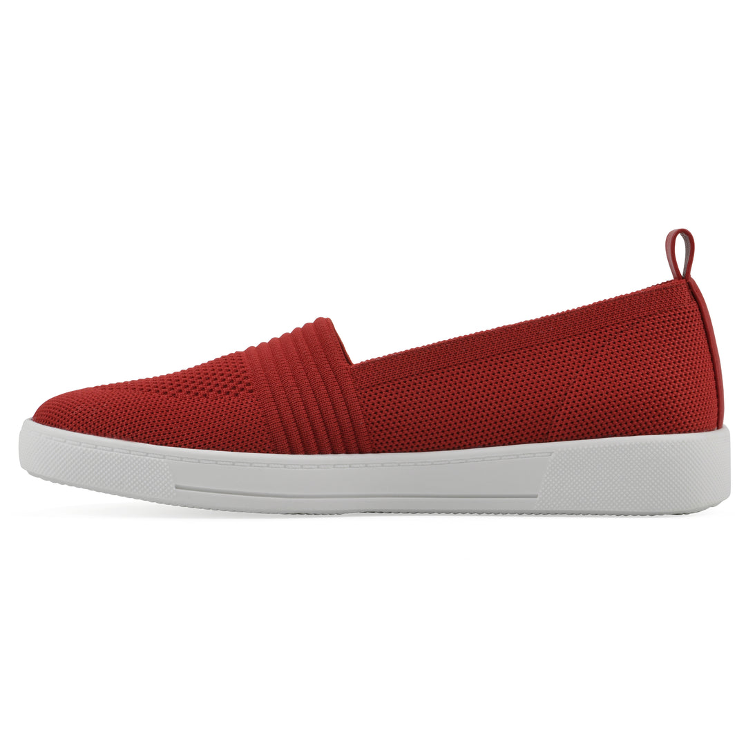 Side view of a red slip-on sneaker with white sole, and perforated mesh fabric