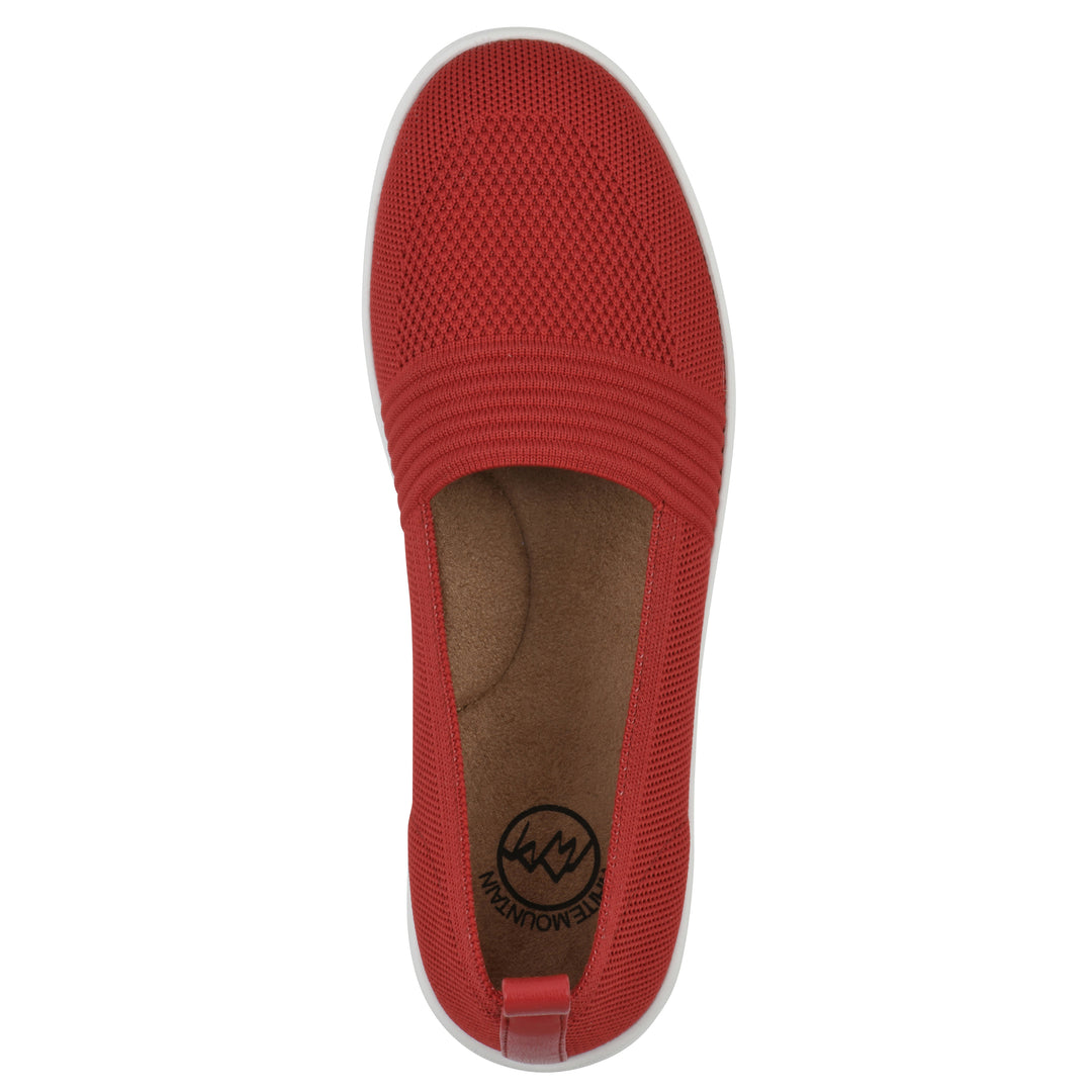Top view of a red slip-on sneaker with white sole, and perforated mesh fabric