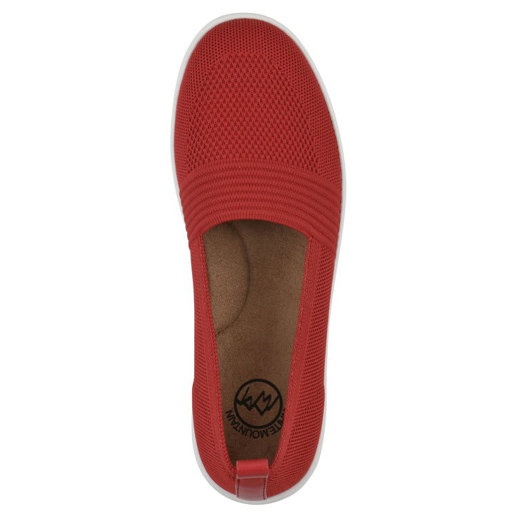 Top view of a red slip-on sneaker with white sole, and perforated mesh fabric
