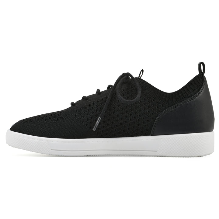 Side view of a black sneaker with white sole, lace-up design and perforated mesh fabric