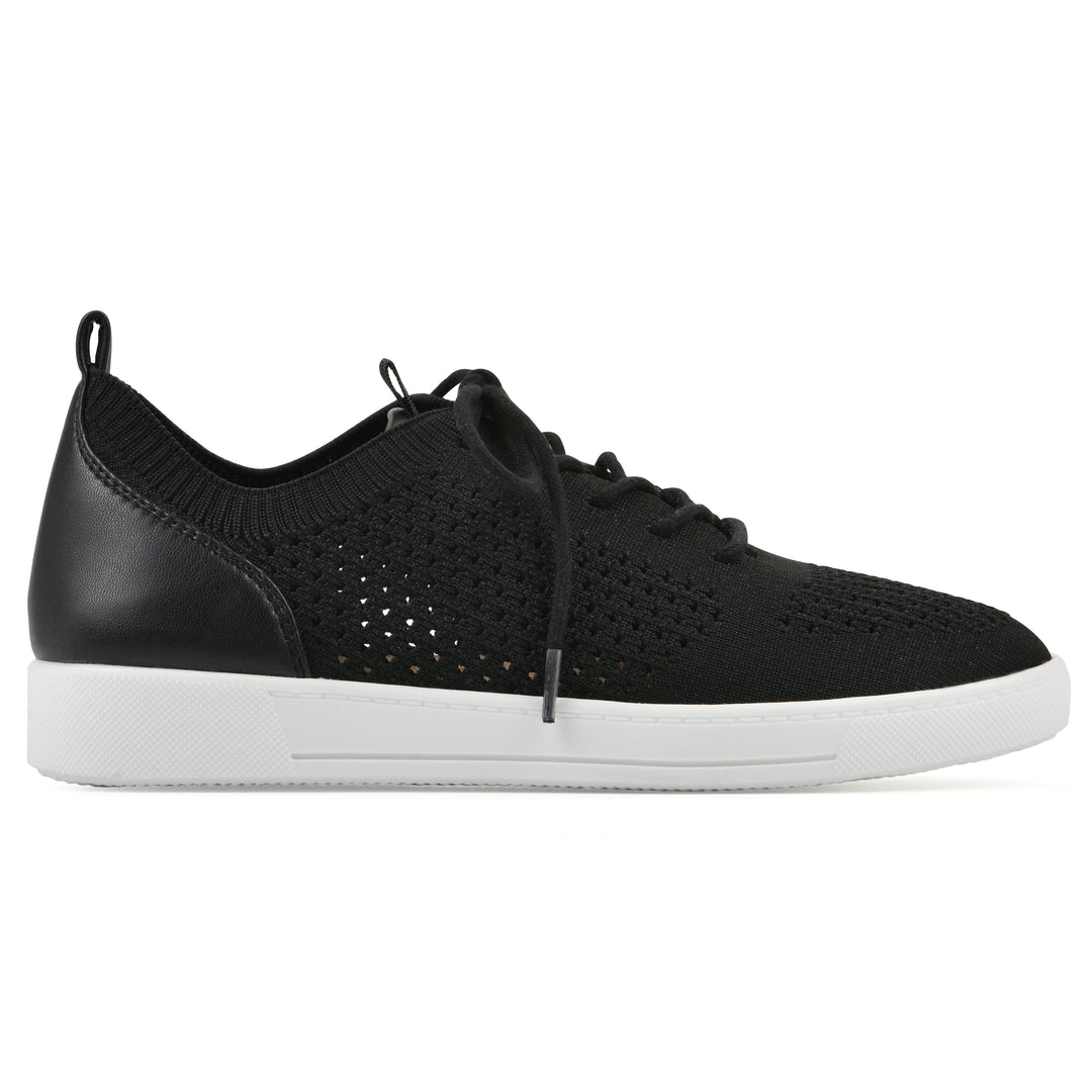 Side view of a black sneaker with white sole, lace-up design and perforated mesh fabric