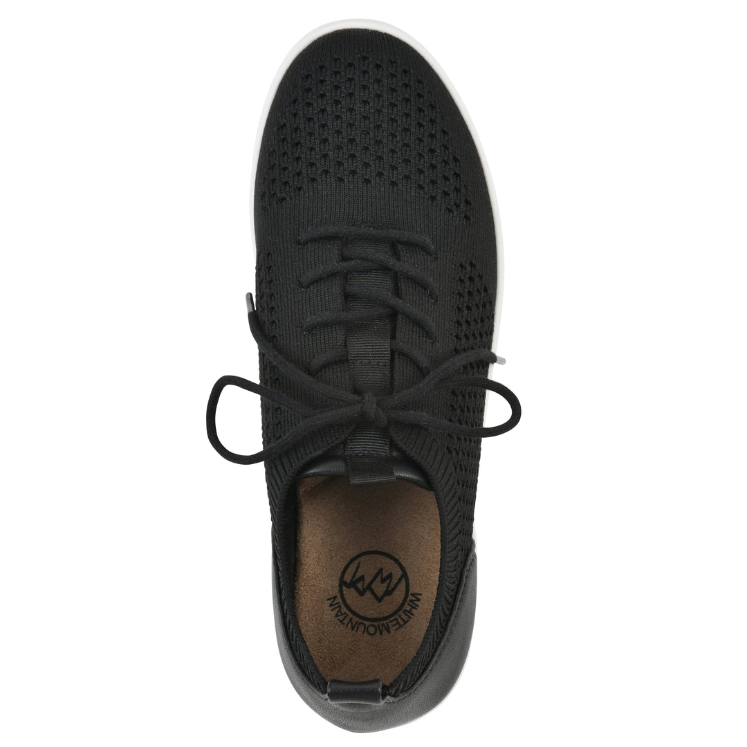 Top view of a black sneaker with white sole, lace-up design and perforated mesh fabric