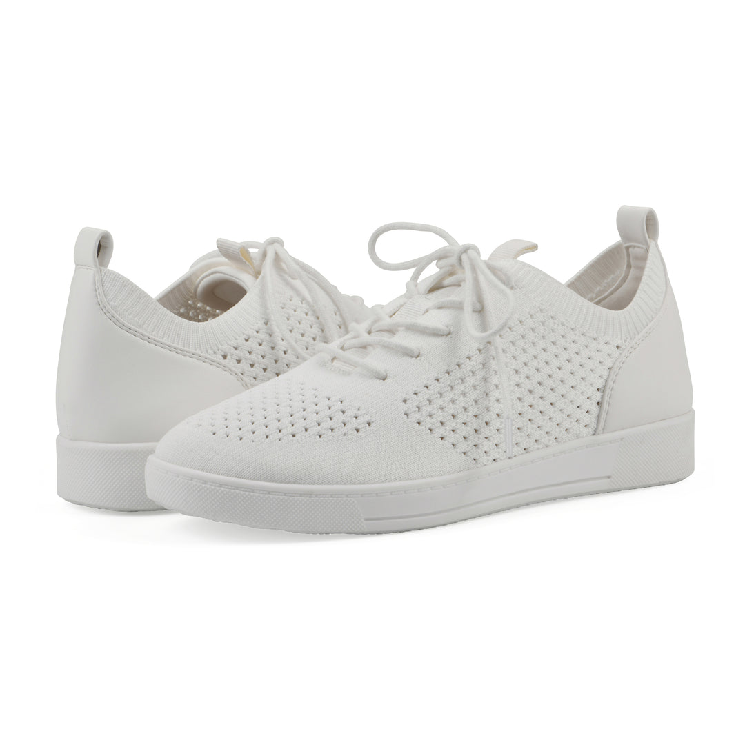 Angle view of a pair of white sneakers with lace-up design and perforated mesh fabric