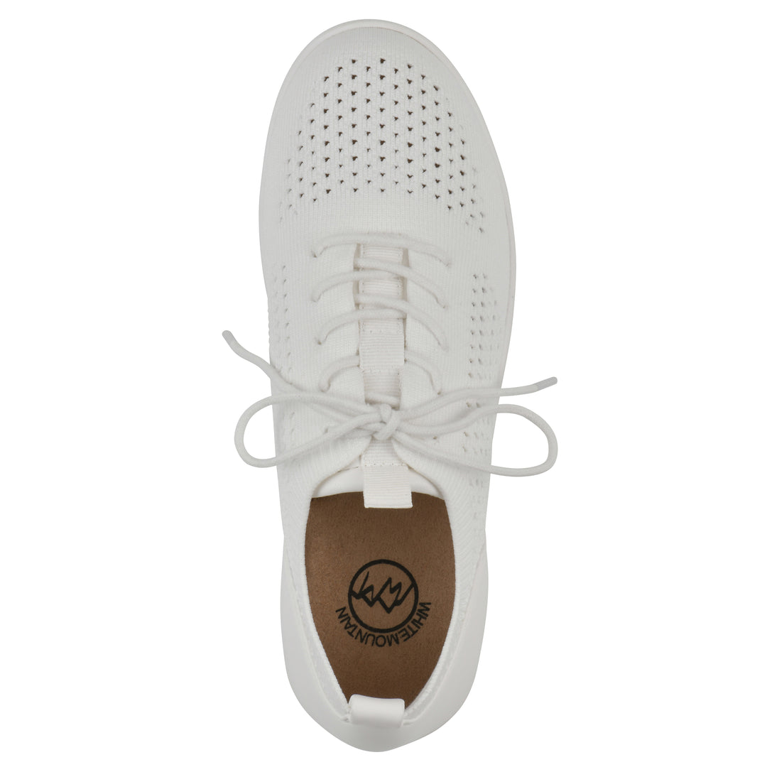Top view of a white sneaker with lace-up design and perforated mesh fabric