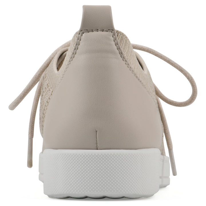 Heel view of a taupe sneaker with lace-up design and perforated mesh fabric