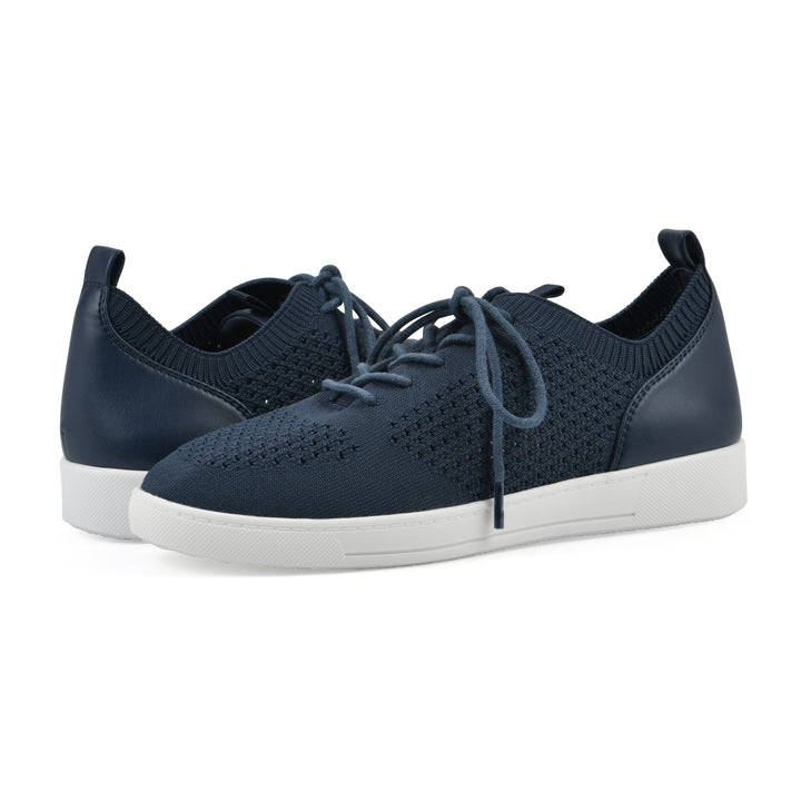 Angle view of a pair of navy sneaker with lace-up design and perforated mesh fabric