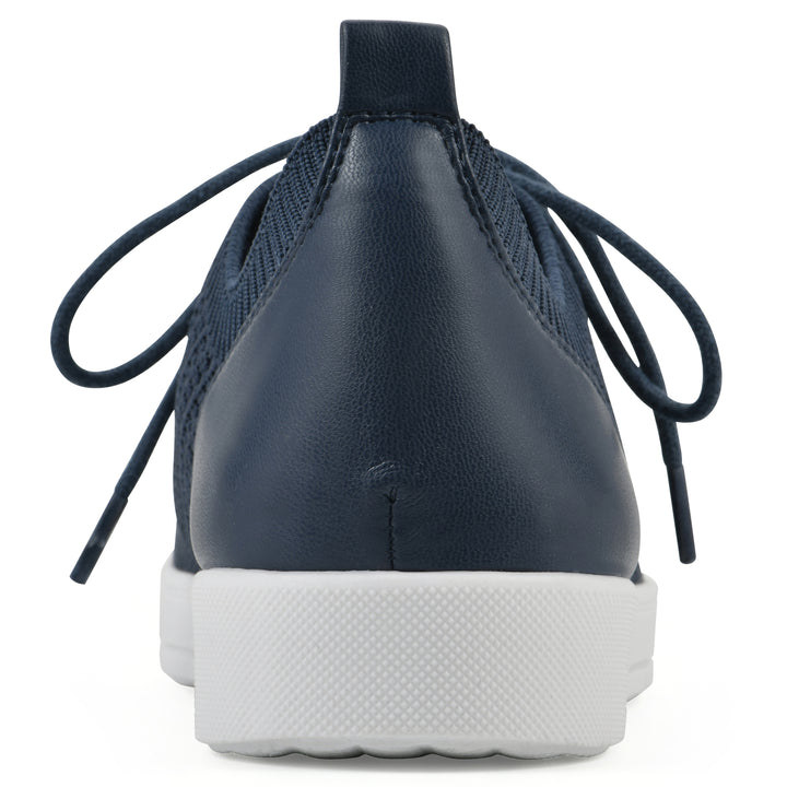 Rear view of a navy sneaker with lace-up design and perforated mesh fabric