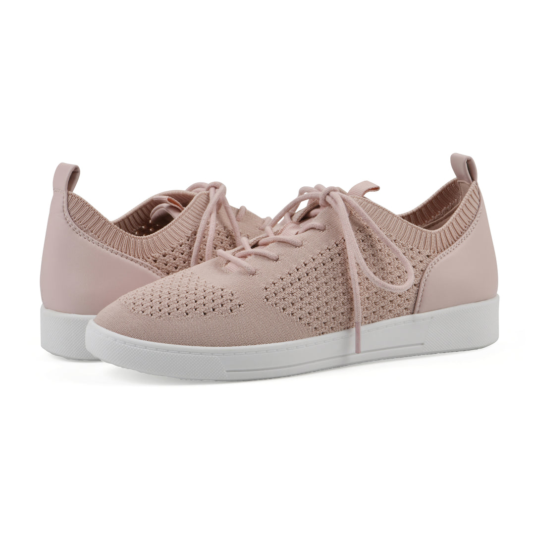 Angle view of a pair of pink sneaker with white sole, lace-up design and perforated mesh fabric